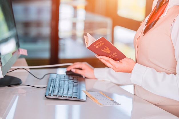 Thailand travel concept Airline officer check in ticket Thai tourist with Passport Visa book at counter service