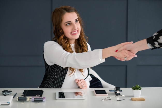 thank you. colleague congratulation handshake. smiling female at perfectly organized workplace. .