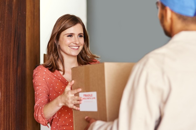 Thank you Cropped shot of a young woman receiving her package from postal worker