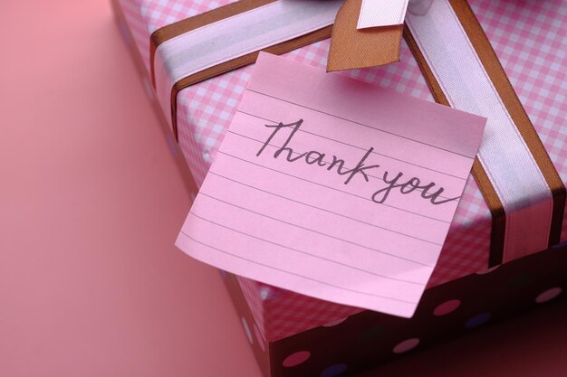 Photo thank you message on gift box on pink background