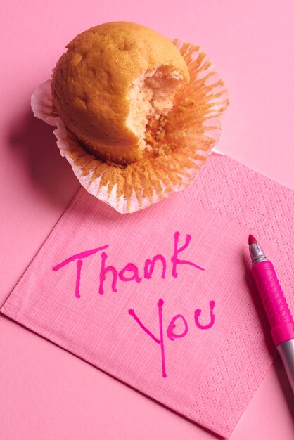 Thank you message handwrote on a pink napkin