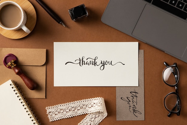 Photo thank you note and laptop flat lay