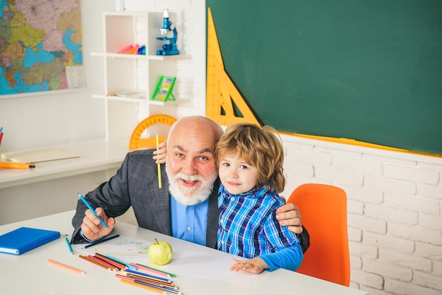 Thank You Teacher Concept of a retirement age Portrait of grandfather and Son in classroom Educational process