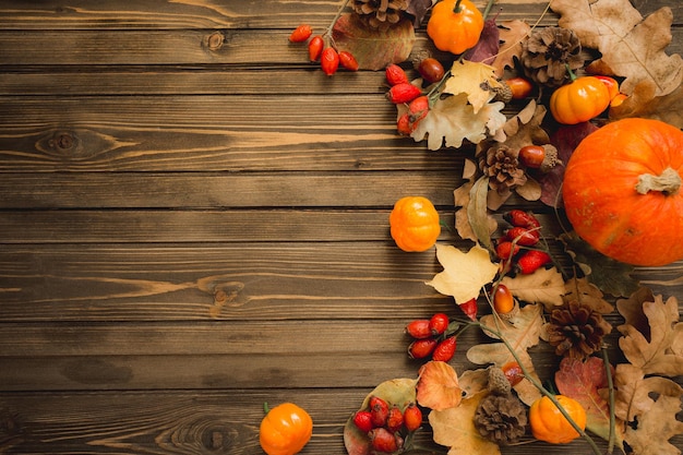 Thanksgiving background Apples pumpkins and fallen leaves on wooden background Copy space for text Halloween Thanksgiving day or seasonal autumnal Design mock up Horizontal