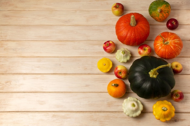 Thanksgiving background with apples, fall green pumpkin on the wooden table, copy space