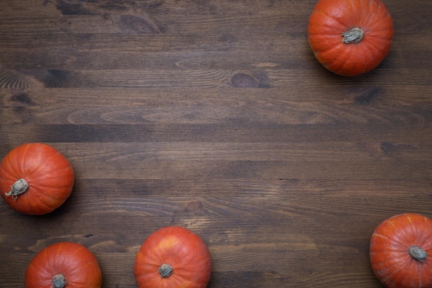 Thanksgiving day concept with pumpkins and autumn leaves, background, top view