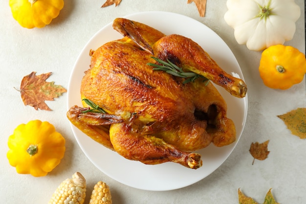 Thanksgiving Day roast turkey on white textured table