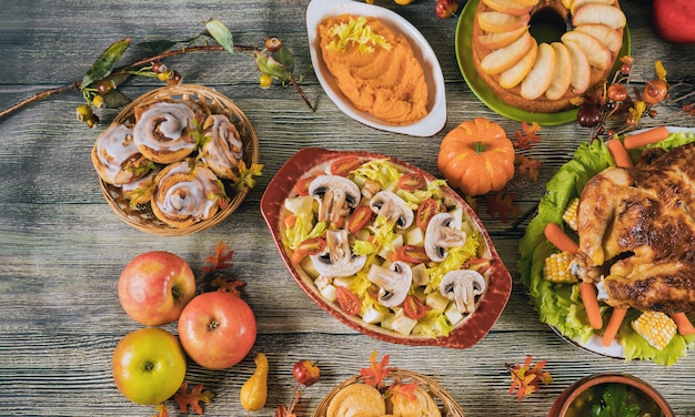 Thanksgiving dinner served with turkey, decorated with autumn leaves and pumpkin.