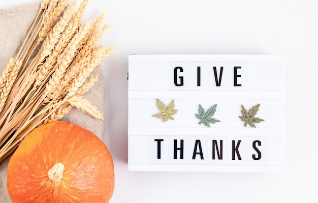 Thanksgiving flat lay composition. Lightbox with the phrase Give thanks. Autumn holidays, fall concept. Mockup, top view, copy space