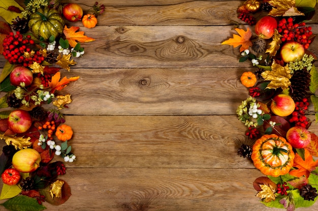 Thanksgiving greeting with frame of pumpkins, apples, berries and leaves