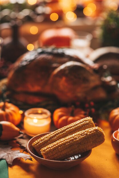 Thanksgiving holiday dinner table setting with fall decoration\
and pumpkins