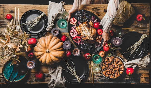 Thanksgiving party table setting with roasted chicken and fig pie