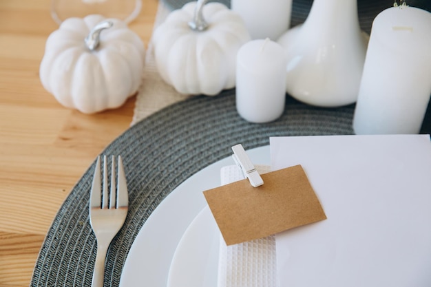 Thanksgiving table setting tableware and decorations Blank white postcard on table mockup