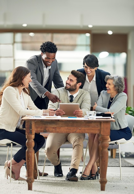 Photo thats awesome cropped shot of a group of businesspeople meeting in the boardroom