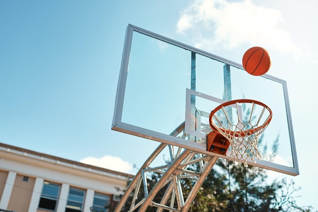 Thats going to be an airball shot Still life shot of a basketball landing into a net on a sports court