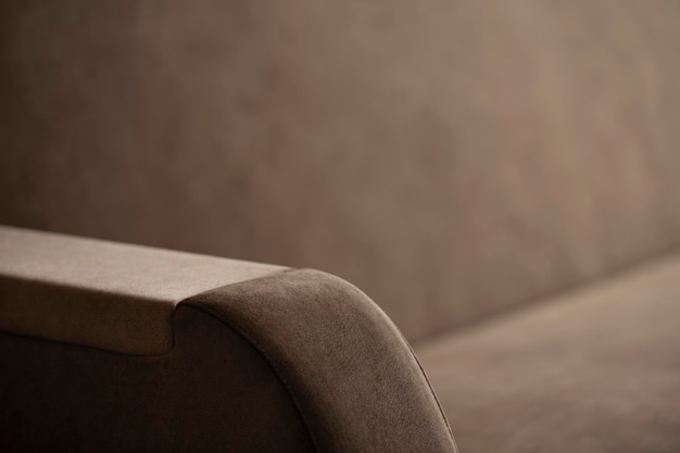 写真 テキストのぼんやりした場所で,毛皮のベージュ色の織物のクローズアップでソファの側面