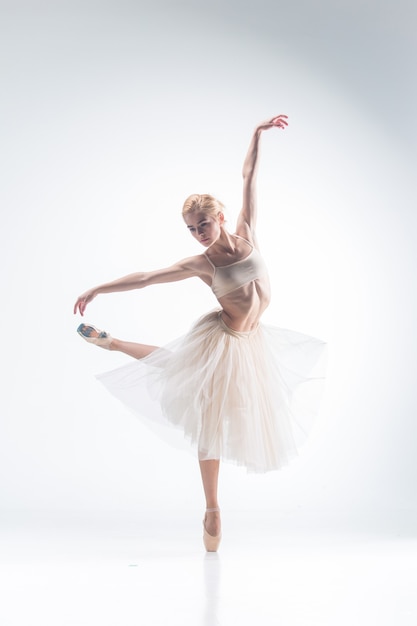Фото Силуэт балерины, танцующей на белом фоне