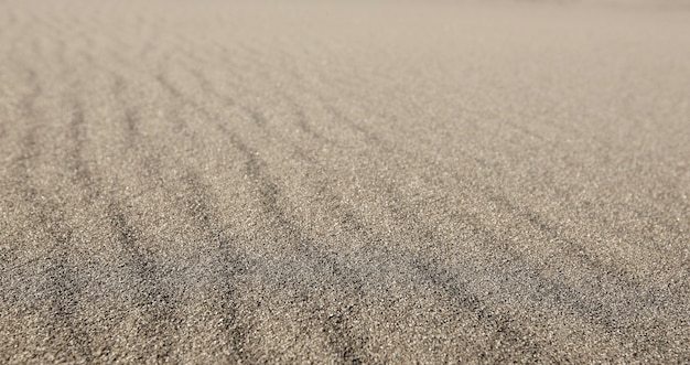사진 프레임 전체에 질감이있는 물결 모양의 회색 모래.