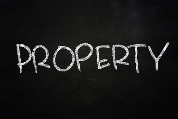 사진 블랙보드에 크레이드로 쓰여진 단어 property