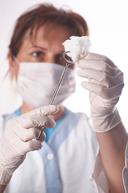 Theater assistant preparing swab for surgeon