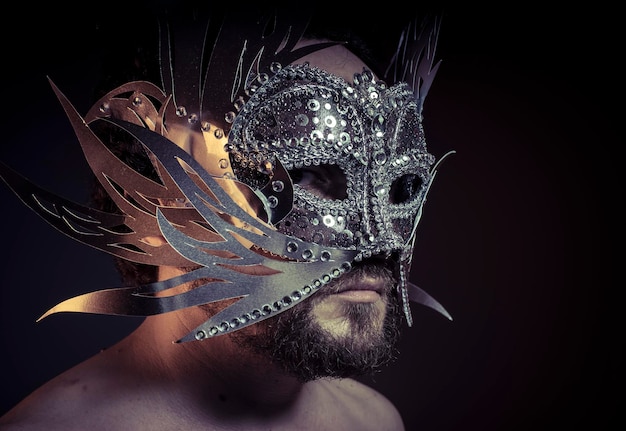 Theater, bearded man with silver mask Venetian style. Mystery and renaissance