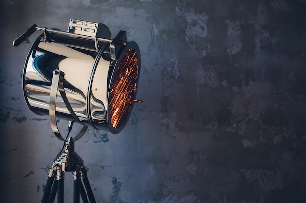 Theater spot light with smoke against grunge wall.