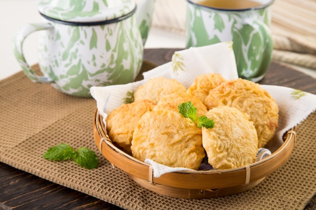 Thee geserveerd met koekjes in een vliezen mandje