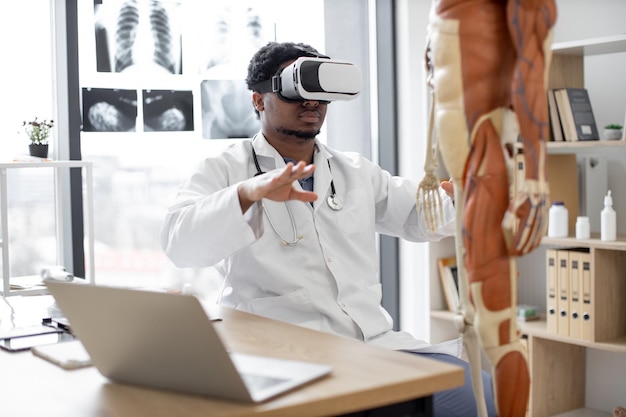 Therapeut met VR-systeem in spreekkamer met skelet