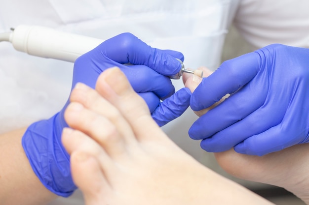 Therapeutic pedicure. Master podologist does hardware pedicure. visit to the podiatry. Foot treatment in the spa. Clinic of Podiatria.