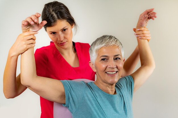 Therapist Checking Senior Womans Arm