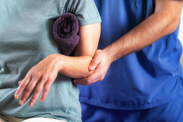 Therapist Checking Senior Womans Arm