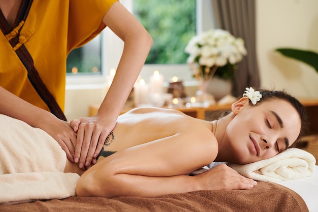 Therapist doing massage in spa salon