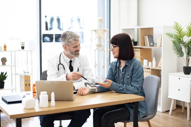 Therapist greeting patient with numbers shown on tonometer