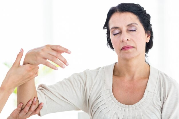 Photo therapist holding her patients arm