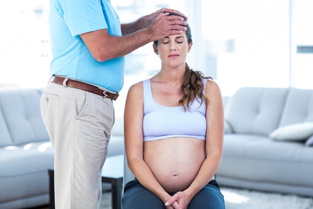 Therapist massaging pregnant woman 