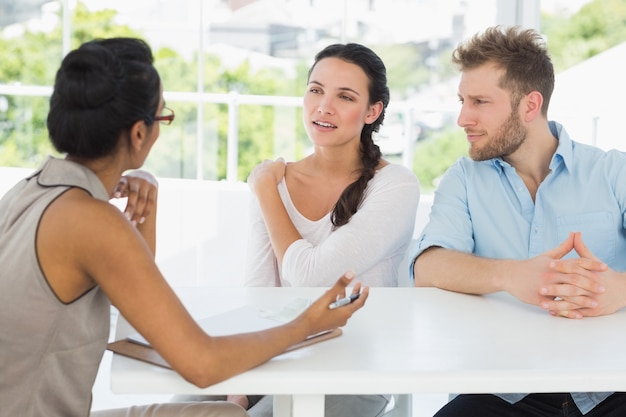 Therapist talking with couple sitting at desk