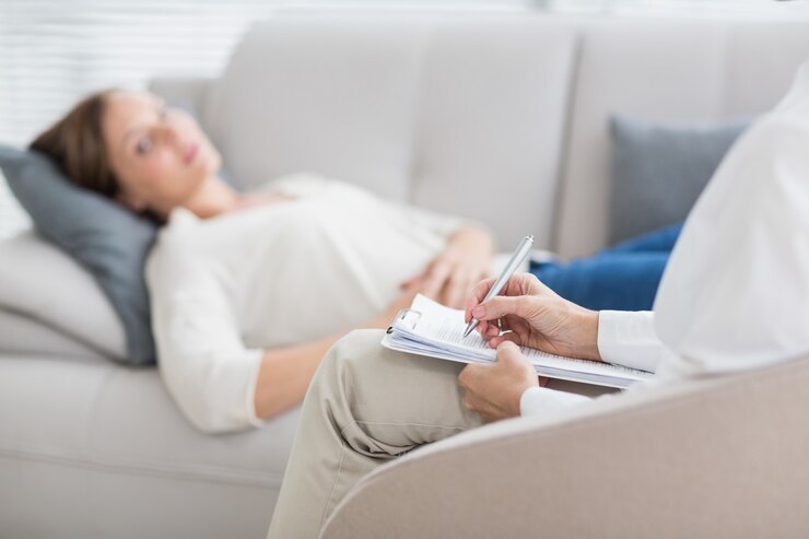 Photo therapist writing notes of patient