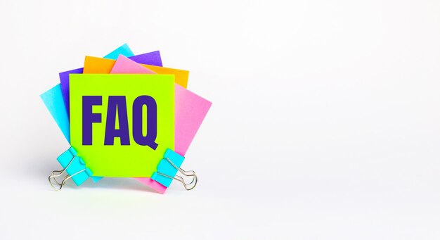 Photo there are bright multi-colored stickers with the text faq on a white background. copy space