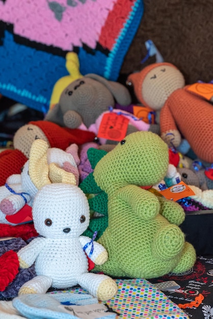 There are a bunch of crocheted toys on the couch