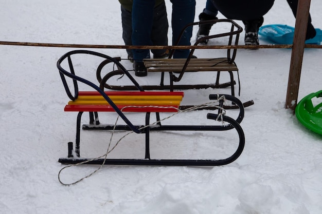 There are children's sleds on the white snow.
