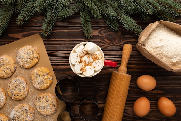 사진 나무 테이블에 핫 초콜릿과 크리스마스 쿠키 한 잔이 있습니다.