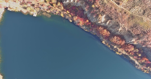 There is an artificial flooded of an old abandoned stone quarry covered with azure water and picturesque flooded landscapes