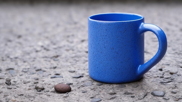 There is a blue coffee cup sitting on the ground with a rock generative ai