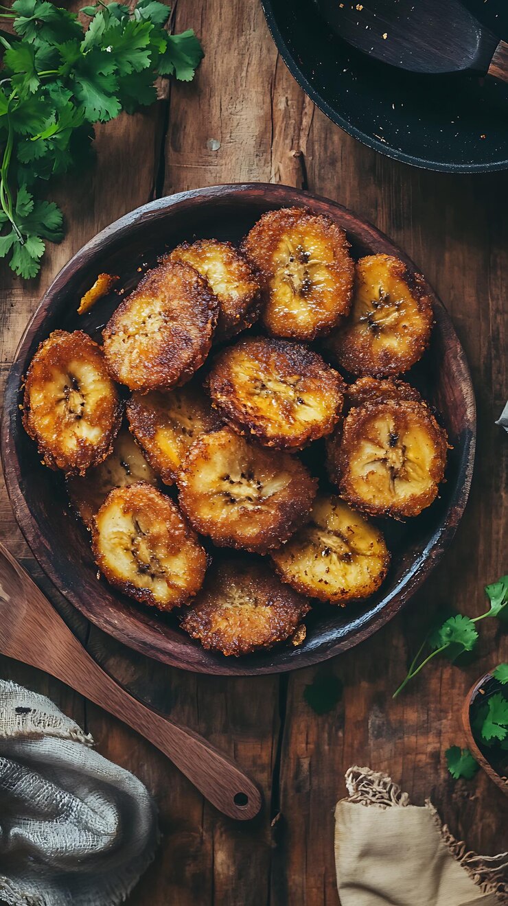 there is a bowl of fried bananas on a wooden table