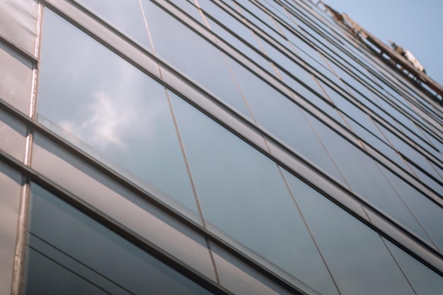 There is glass a beautiful glass building with windows reflecting the sun, background