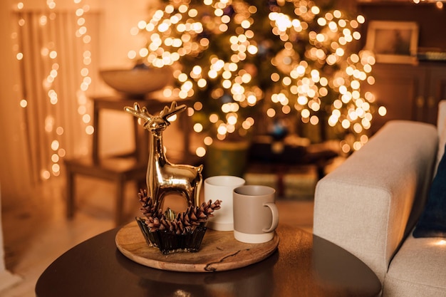 There were two cups and a New Years deer on a wooden table