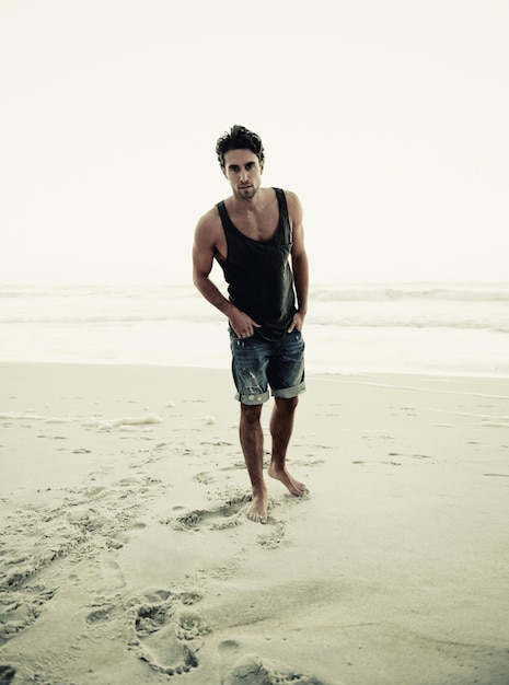 Theres no better place to relax Cropped shot of a handsome young man on the beach