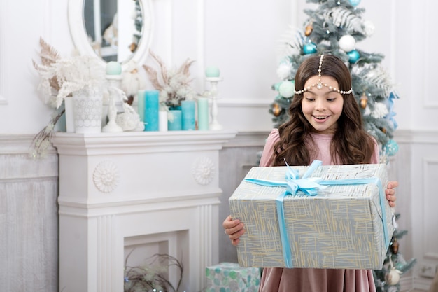 Theres no surprise bigger. Surprised child. Little girl hold surprise box. Happy kid celebratexmas and new year. Receiving Christmas surprise. Happy holidays. Surprise inside gift pack.