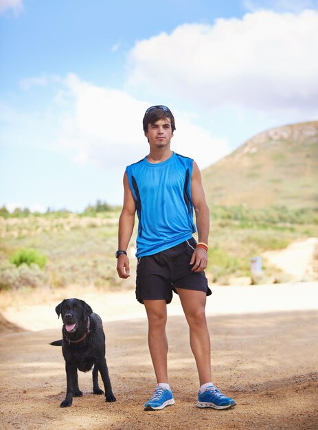 Theres nothing like fresh air and exercise shot of a young man exercising outdoors with his dog