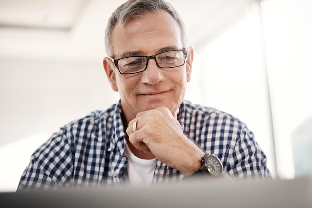 Theres so much to discover online Shot of a mature man working on a laptop at home